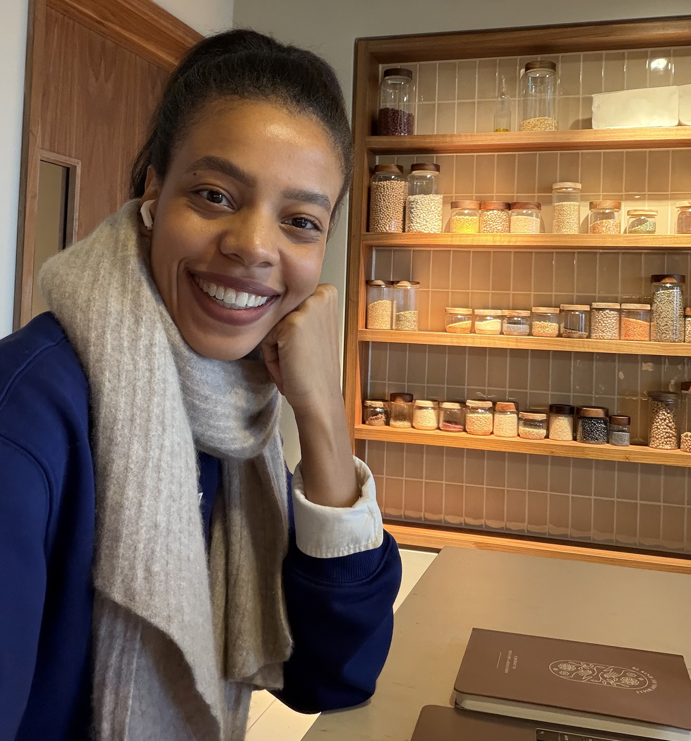 Meaghan Zori smiling, resting her chin on her hand at a sunlit kitchen counter